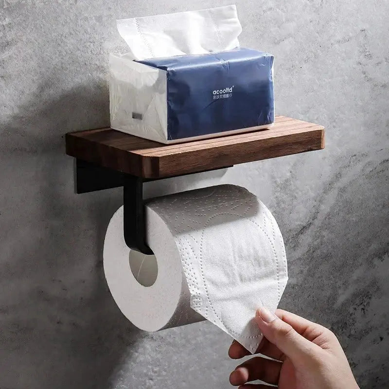 Walnut toilet paper holder with integrated shelf in a calm bathroom setting.
