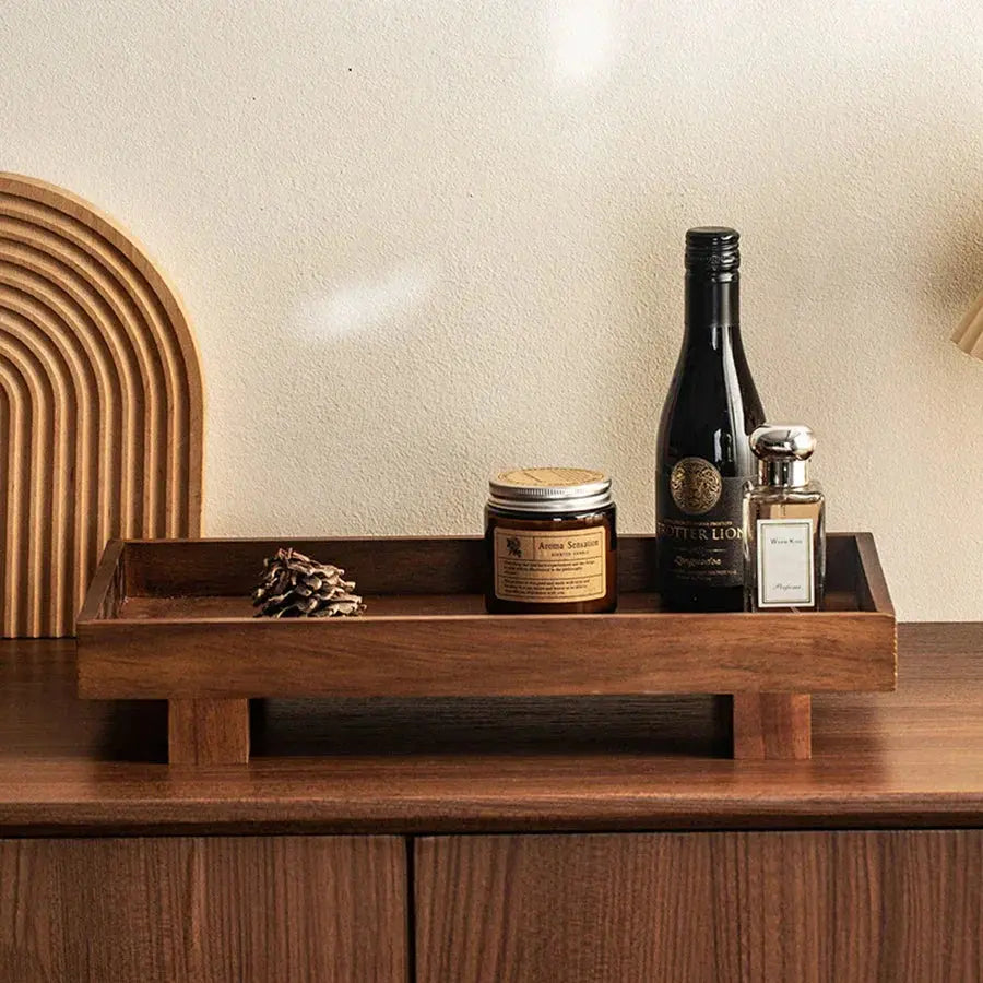 The Grove Oak Wood Serving Tray styled with candles, wine, and decorative items on a wooden surface.