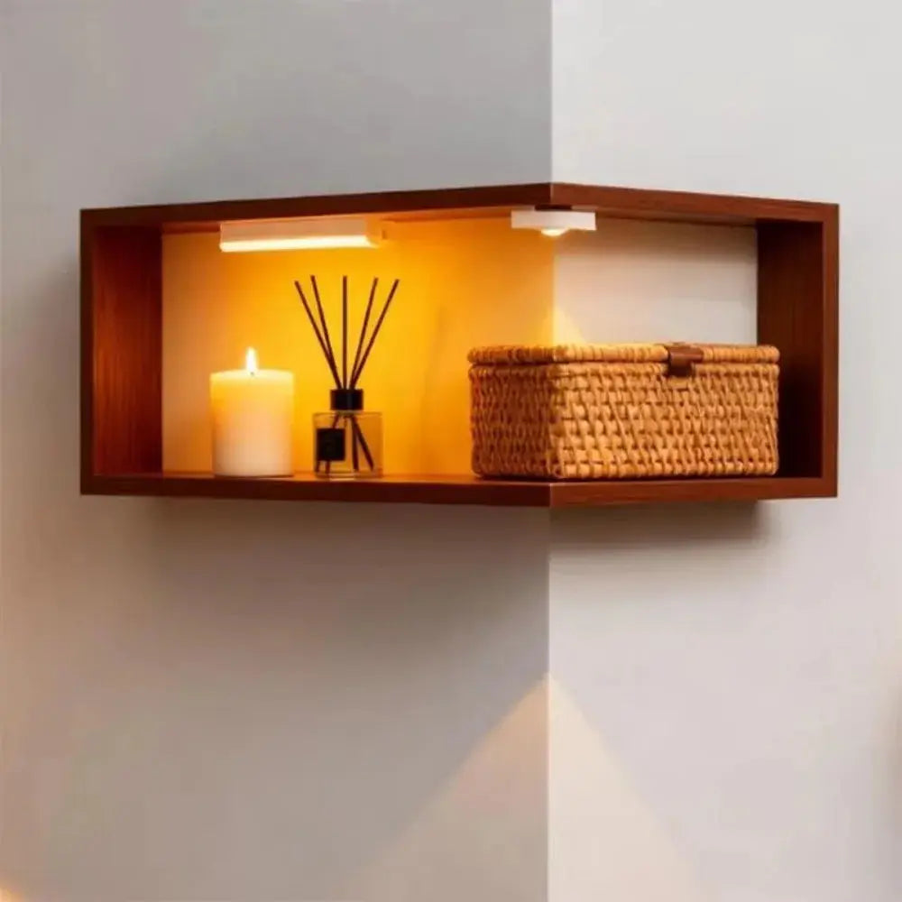 The Nook Floating Corner Shelf showcasing a candle and decorative basket in a modern corner design.